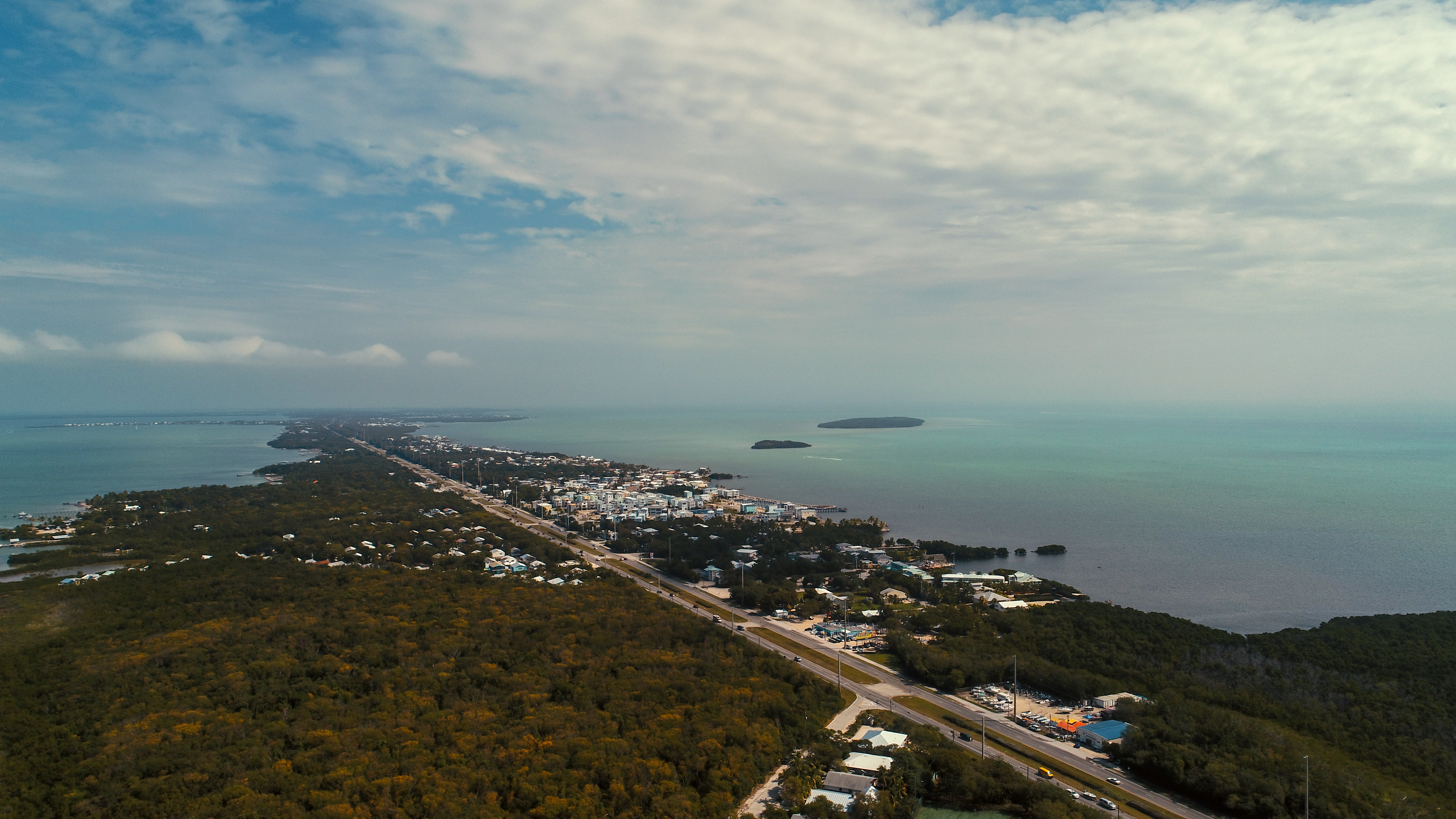 Aerial Photo of Key Largo, with the Ocean and multiple homes visible in the frame