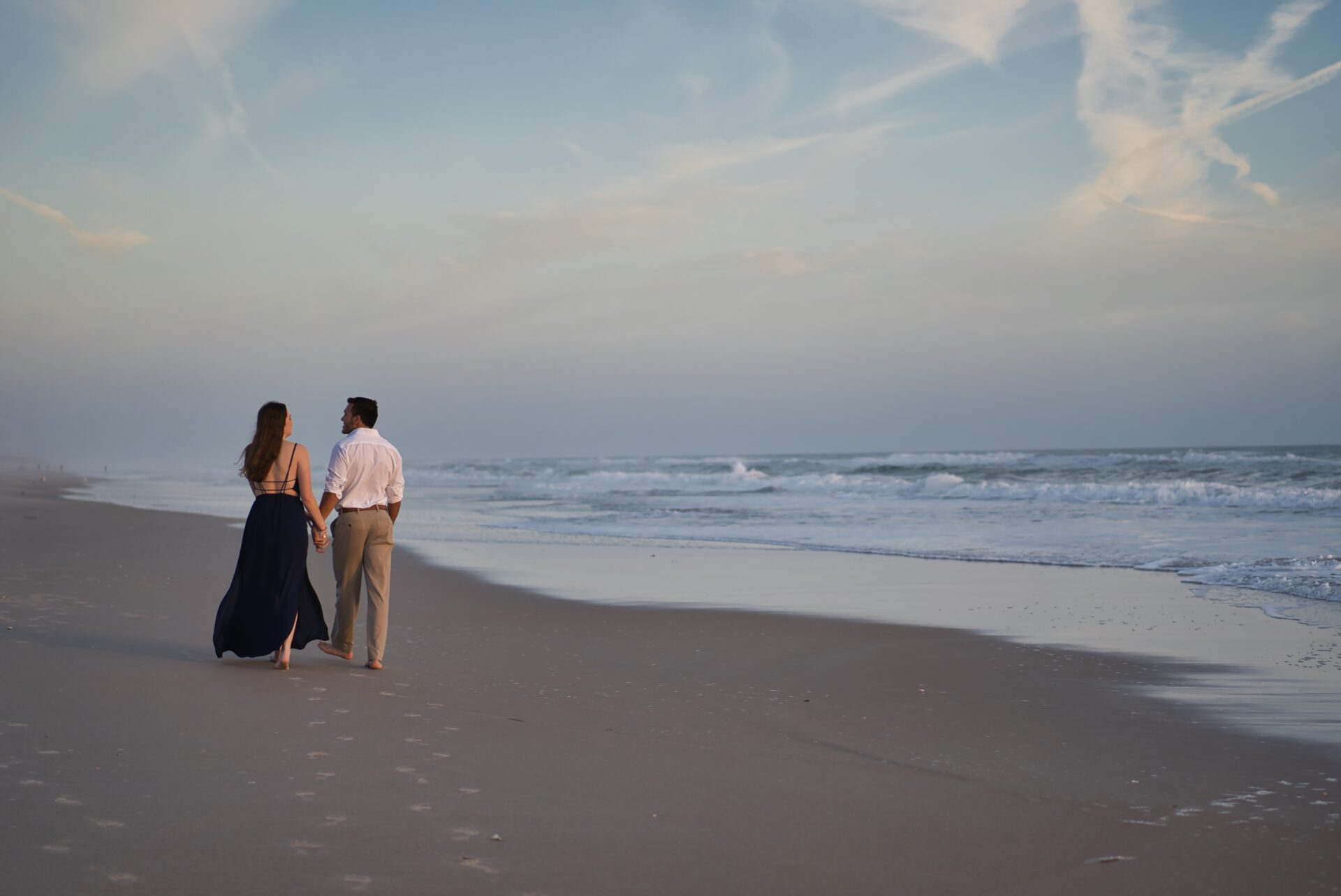 Couple Walking on the beach at sunrise in Cocoa Beach Florida, taken by Van Hook Media