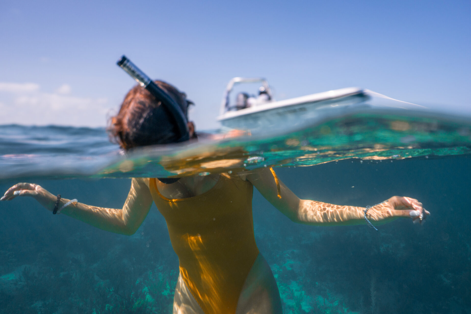 Over-Under shot of a girl snorkeling in the florida keys